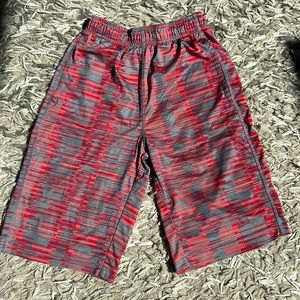 Nike youth L grey athletic shorts with red and peach accents.